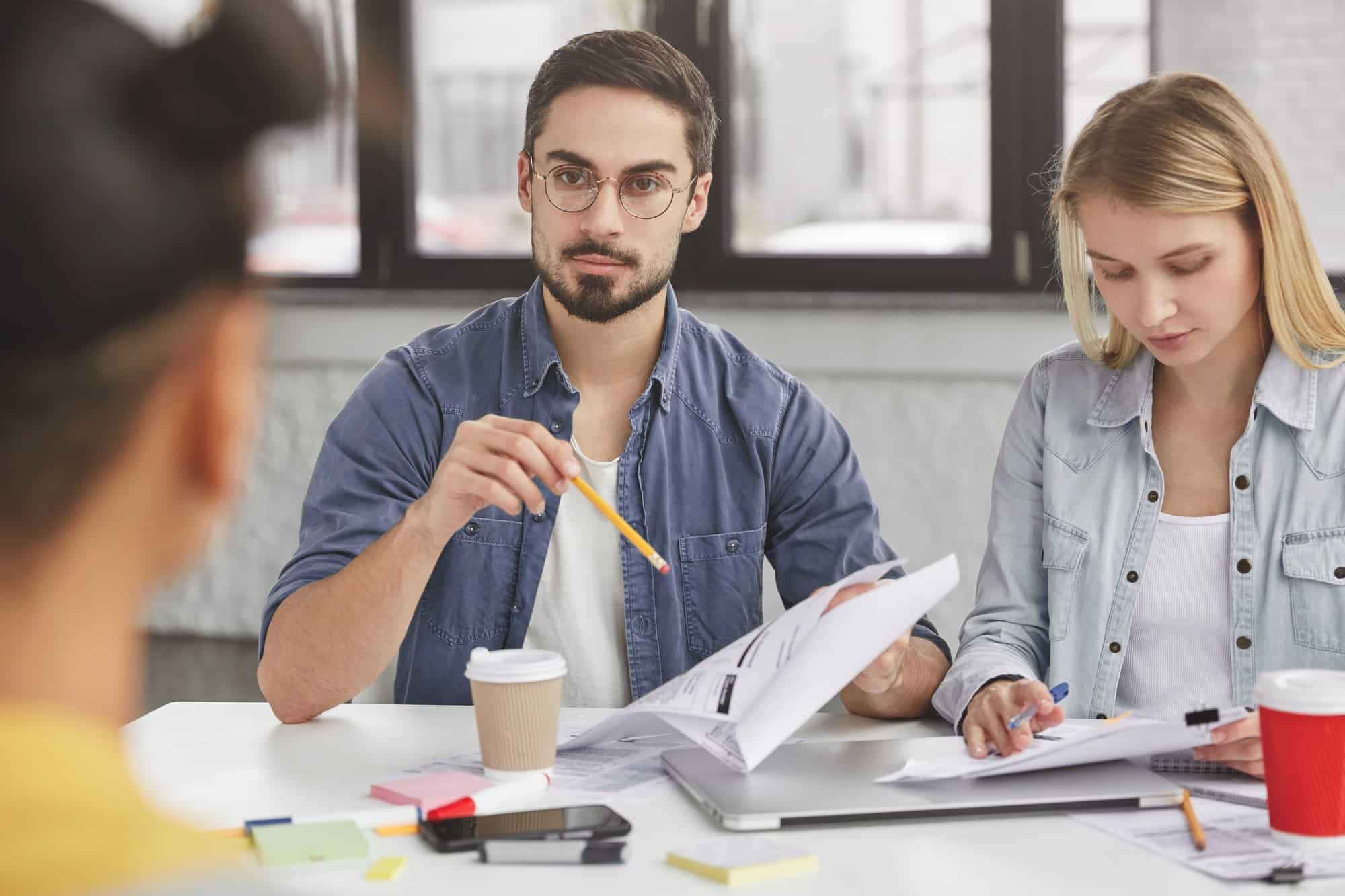 young-colleagues-have-formal-meeting-discuss-solutions-study-documents-prepare-marketing-project-.jpg young-colleagues-have-formal-meeting-discuss-solutions-study-documents-prepare-marketing-project-.jpg